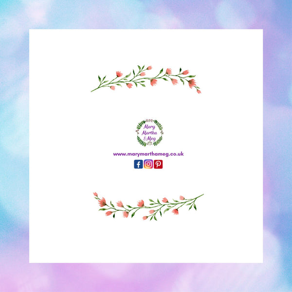 The reverse of a floral wreath greeting card by Mary, Martha & Meg pictured against a pastel blue and purple background. The card shows the Mary, Martha & Meg logo at its centre, underneath are references to Mary, Martha & Meg social media sites. Above and below the images are a delicate spray of pink flowers and green leaves.
