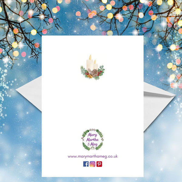 The back of a Mary, Martha & Meg Christmas Greetings card shows a smaller image of the Christmas candles which feature on the front of the card. The Mary, Martha & Meg logo is also featured, with a reference to this Christian business website: www.marymarthameg.co.uk as well as the logos for Facebook, Instagram and Pinterest, where this Mary, Martha & Meg can be contacted. The Christmas card is photographed on a blue background with twigs decorated with small, pastel-coloured lights.