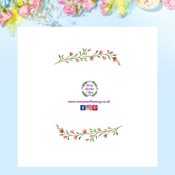 The reverse of a beautiful floral wreath Easter greeting card by Mary, Martha & Meg pictured against a sky-blue background with pink and yellow flowers at the top. card to share the joy of Easter with others. The card shows the Mary, Martha & Meg logo at its centre, underneath are references to Mary, Martha & Meg social media sites. Above and below the images are a delicate spray of pink flowers and green leaves.