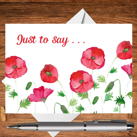 A beautiful greetings card created from an original Mary, Martha & Meg hand-painted watercolour. This beautiful design features red poppies with the text in the top left corner reading, ‘Just to say …’ It is a perfect postcard for keeping at hand when you just want to write a note to someone. The beautiful postcard is photographed on a wooden writing surface with a white envelope peeping out behind the greetings card. There a silver pen beneath the Just to Say card.