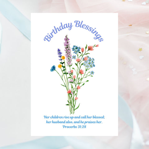 This Mary, Martha & Meg card features a simple, delicate floral bouquet, above which are written the words, ‘Birthday Blessings.’ The Bible verse written underneath the flowers is the well-known verse from Proverbs 31:28, “Her children rise up and call her blessed; her husband also, and he praises her.” The white A6 card is pictured on pale pastel pink and blue chiffon. A perfect card to give a mum celebrating her birthday.