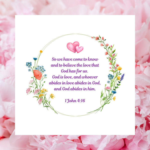 A beautiful white square card pictured against a background of pink rose petals. The design of this Mary, Martha & Meg card has a lovely floral wreath framing the Bible verse, “So we have come to know and to believe the love that God has for us. God is love, and whoever abides in love abides in God, and God abides in Him.” 1 John 4:16. Above the Bible verse are two pink intertwined hearts. This beautiful card is ideal for celebrating an engagement, wedding or anniversary. 
