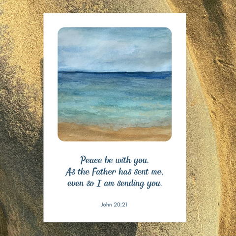 A professionally printed greetings card of an original seashore painting by Meg. The calming waves lap the golden sand. The scripture text reads, “Peace be with you. As the Father has sent me, even so I am sending you.” John 20:21. The white greetings card is pictured against a background of a sandy beach. A perfect card for many occasions, including baptism, being commissioned, starting a ministry, or simply as an encouragement for all Christians.