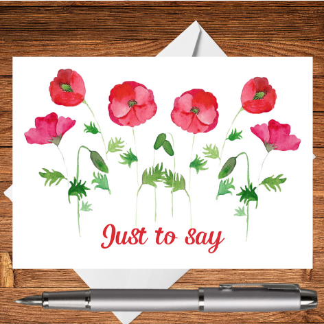 A beautiful greetings card created from an original Mary, Martha & Meg hand-painted watercolour. This beautiful design features red poppies with the text ‘Just to say …’ It is a perfect postcard for keeping at hand when you just want to write a note to someone. The beautiful postcard is photographed on a wooden writing surface with a white envelope peeping out behind the greetings card. There a silver pen beneath the Just to Say card.