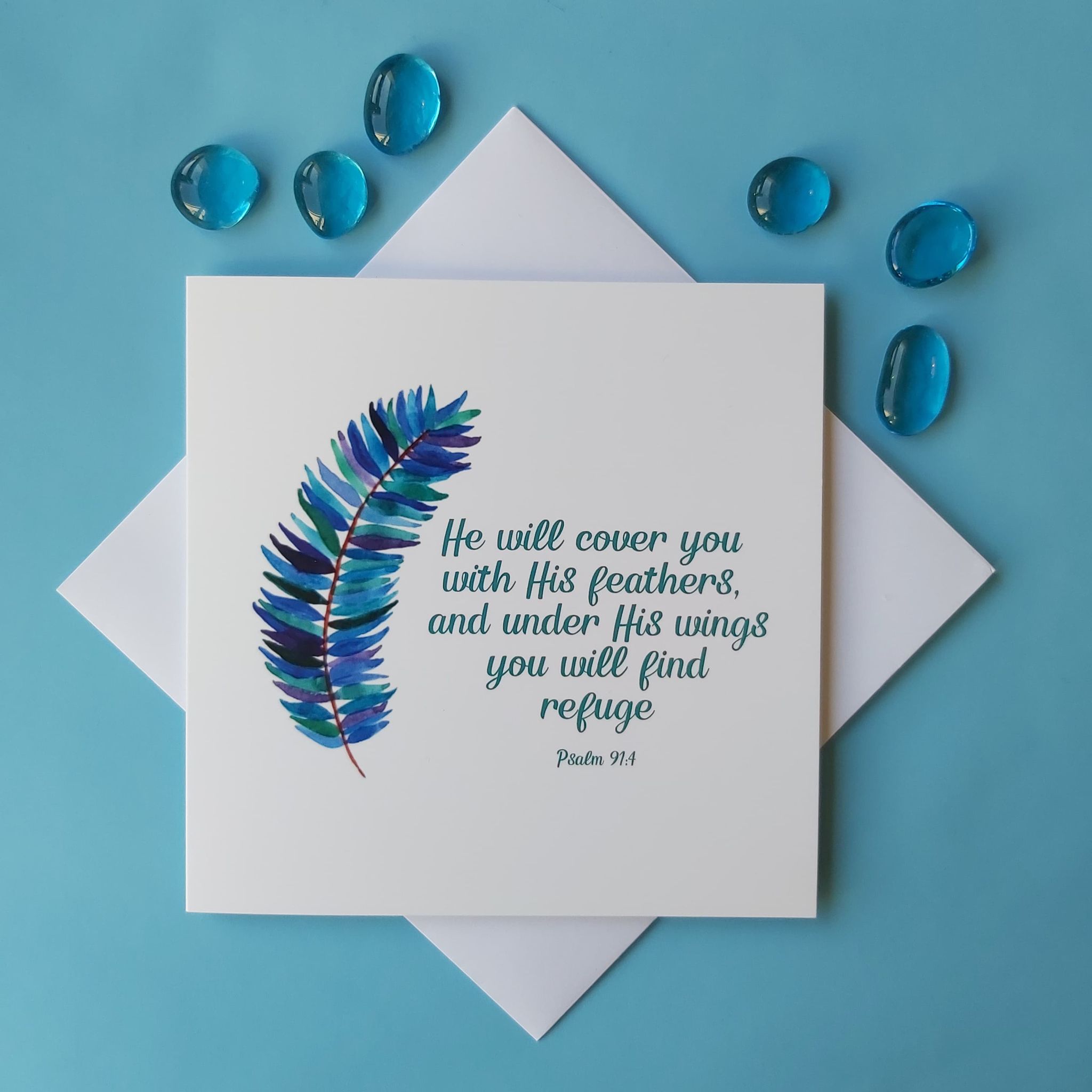 He will cover you with His feathers - Psalm 91:4. Blue watercolour feather design with teal text.